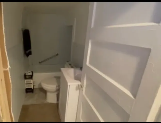 a kitchen with a sink a stove and cabinets