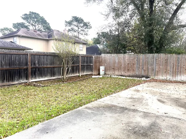 a view of a backyard with a small cabin and a chair