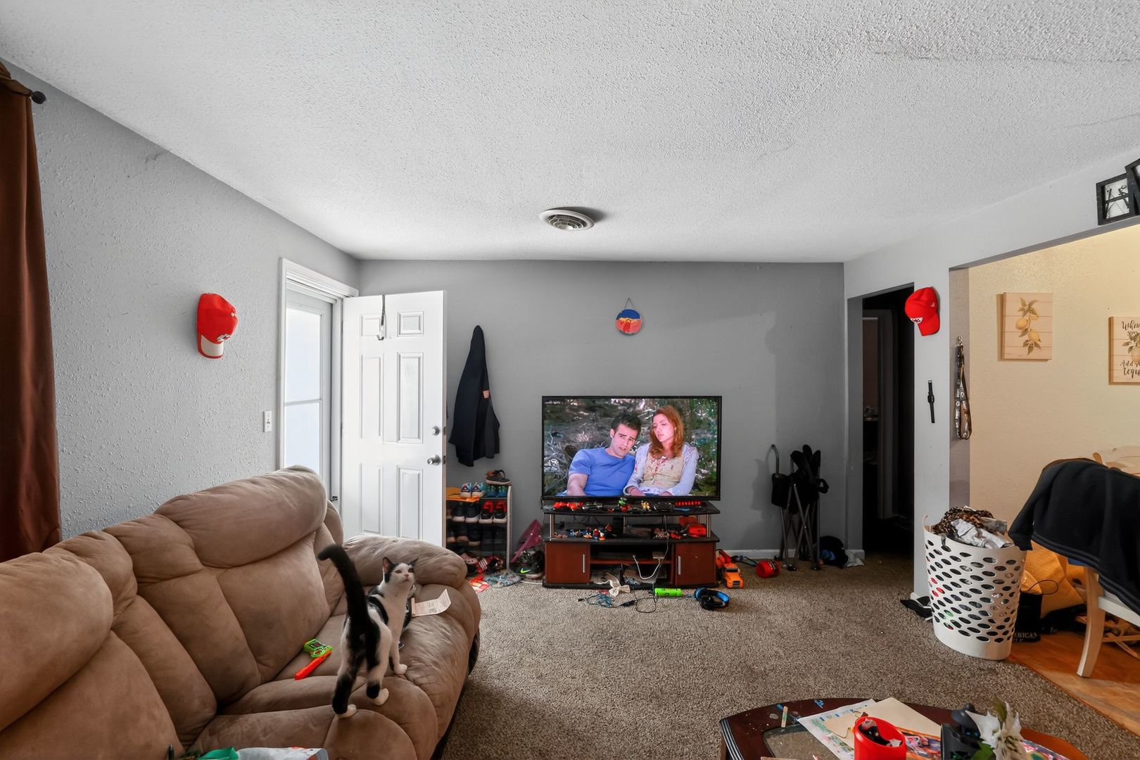 210 James Street Bethalto, IL 62010 - Photo 2 of 15 a living room with furniture and a flat screen tv