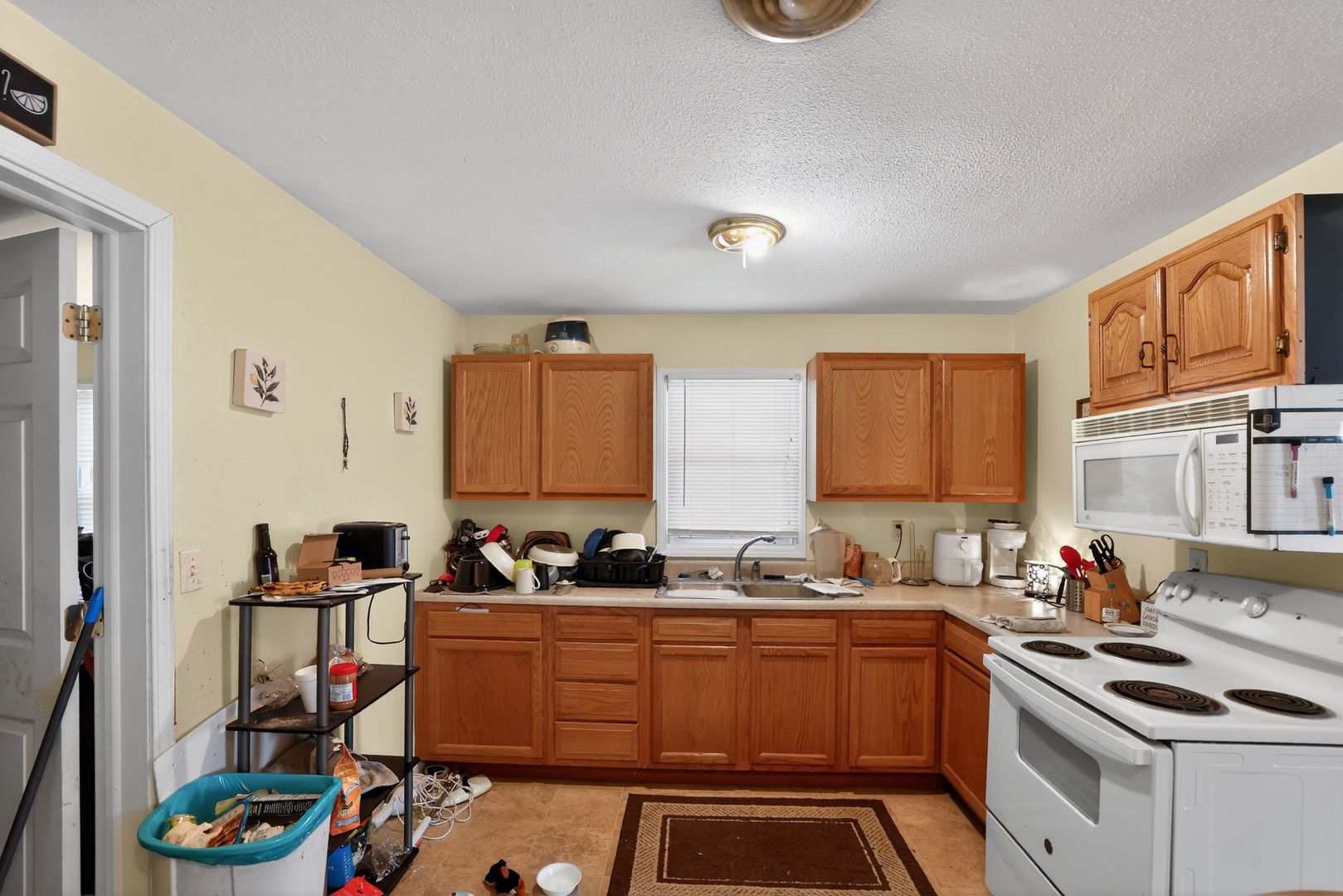210 James Street Bethalto, IL 62010 - Photo 6 of 15 a kitchen that has a sink and a stove in it