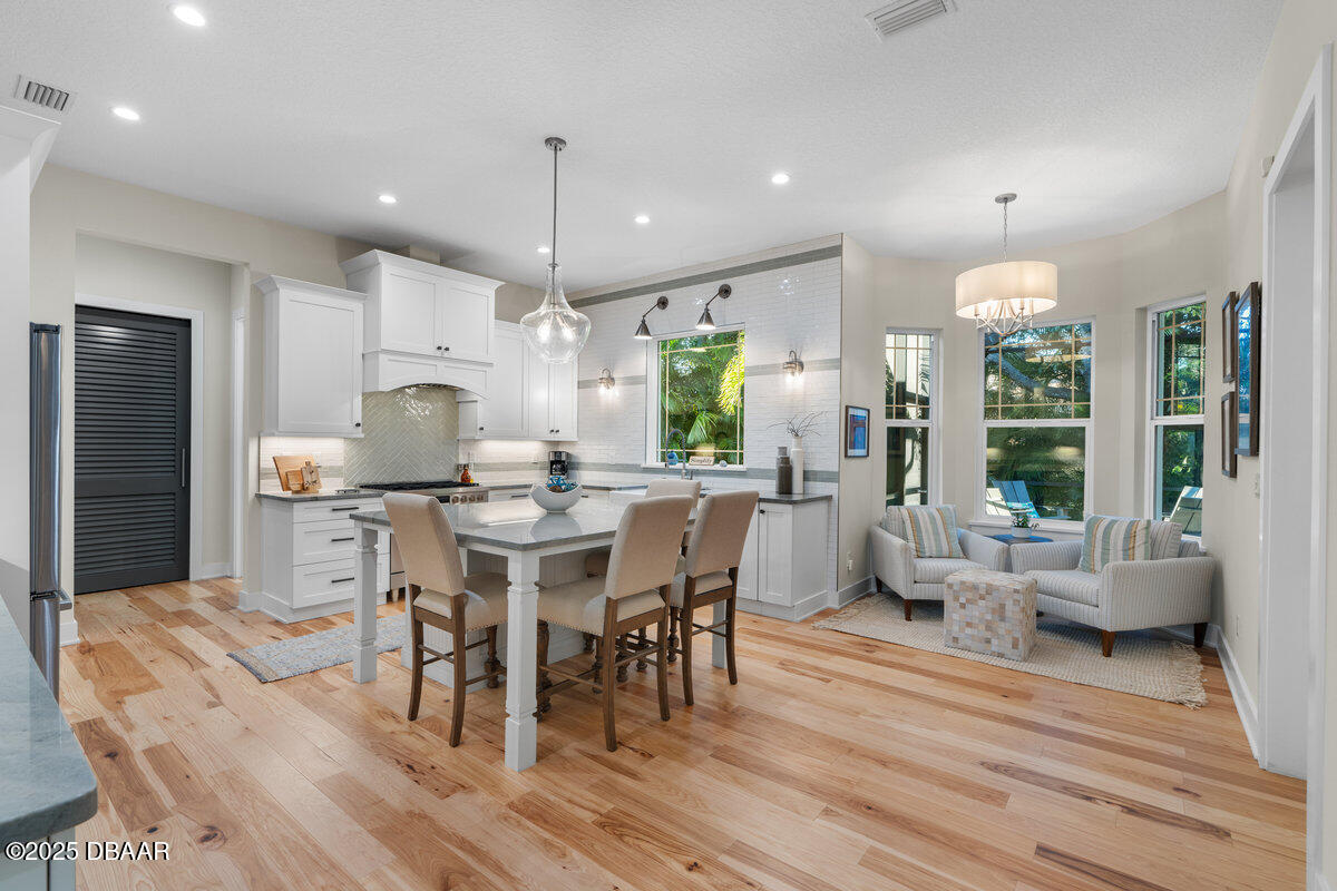 54 Ocean Way Drive Ponce Inlet, FL 32127 - Photo 12 of 76 a kitchen with stainless steel appliances kitchen island granite countertop a table chairs and a dining table view