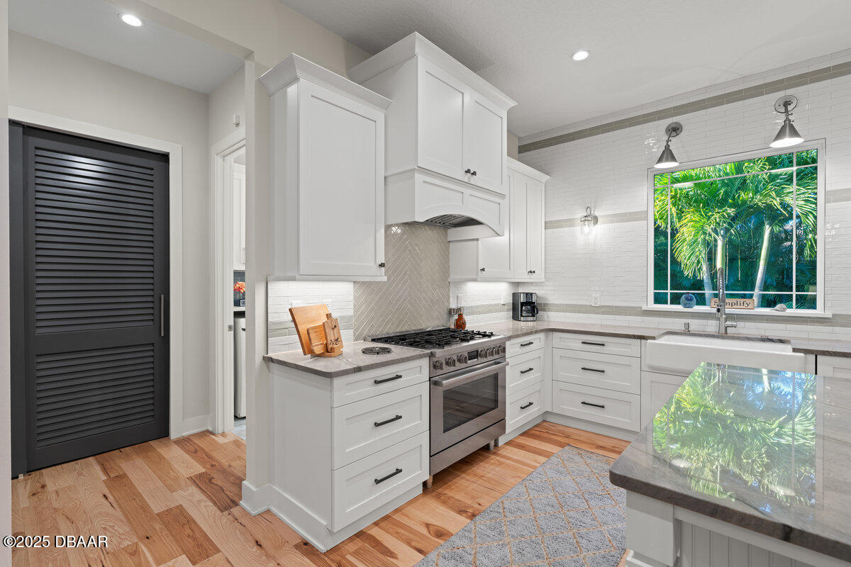 54 Ocean Way Drive Ponce Inlet, FL 32127 - Photo 18 of 76 a kitchen with stainless steel appliances granite countertop a stove a sink and a refrigerator