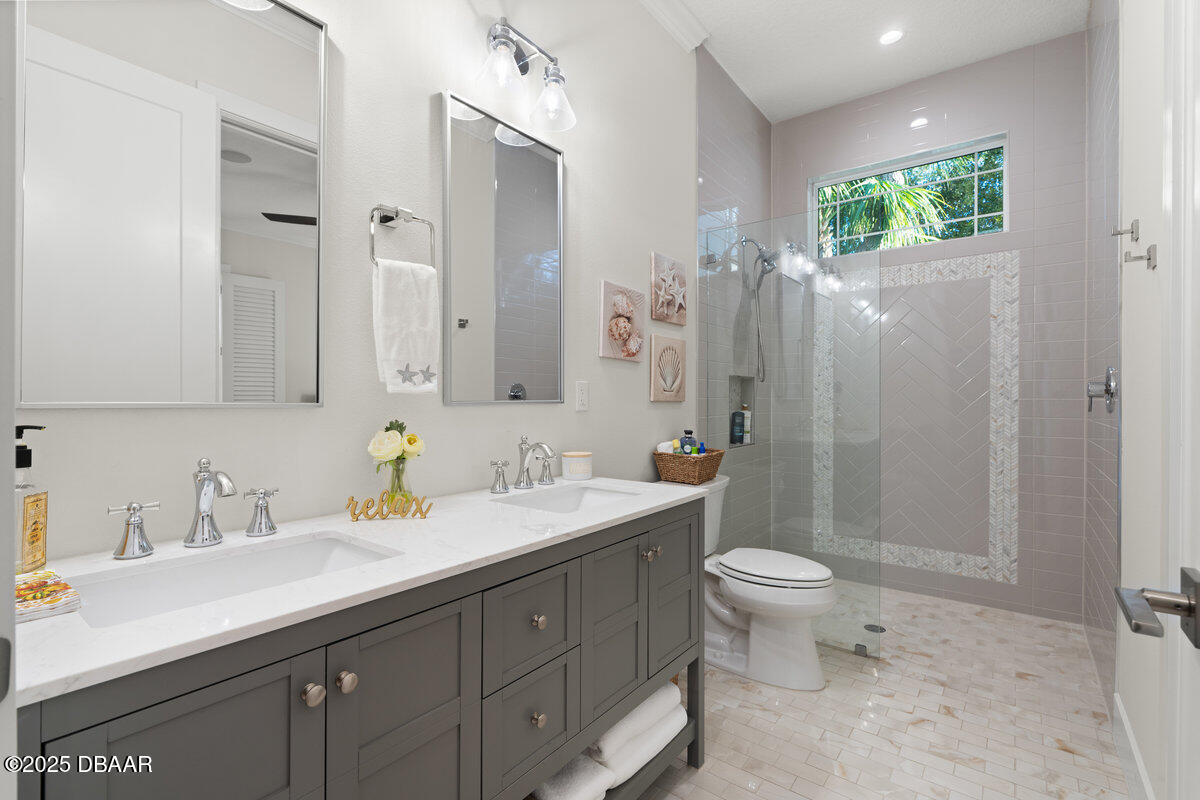 54 Ocean Way Drive Ponce Inlet, FL 32127 - Photo 20 of 76 a bathroom with a sink toilet and shower