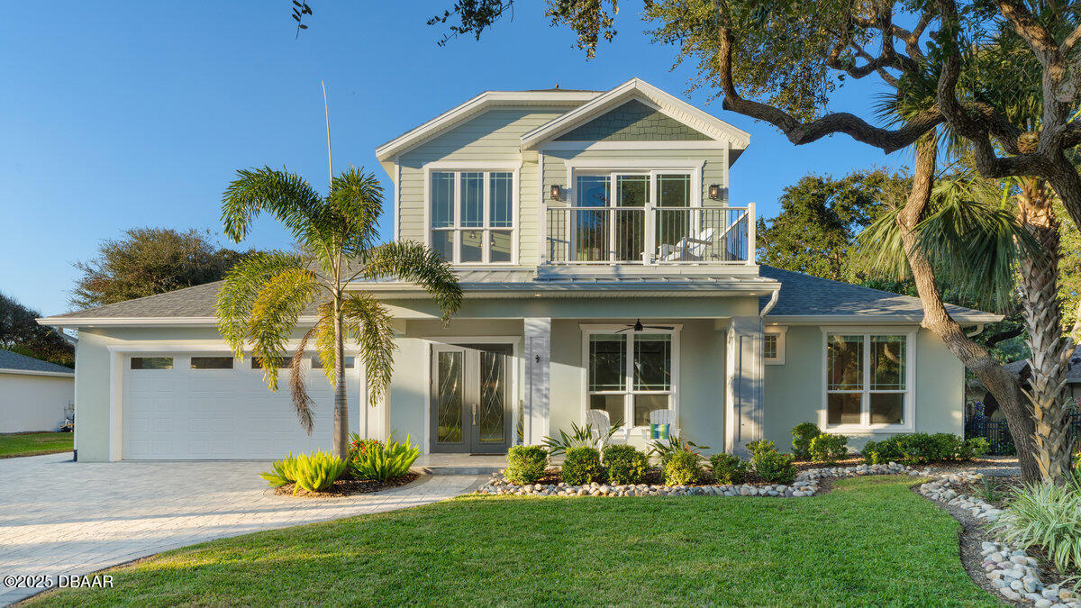 54 Ocean Way Drive Ponce Inlet, FL 32127 - Photo 2 of 76 a front view of a house with a garden and plants