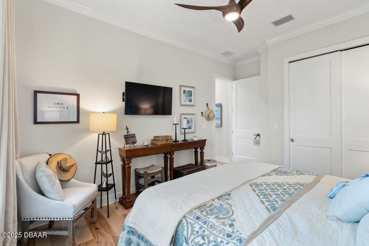 54 Ocean Way Drive Ponce Inlet, FL 32127 - Photo 22 of 76 a bedroom with a bed and a chair