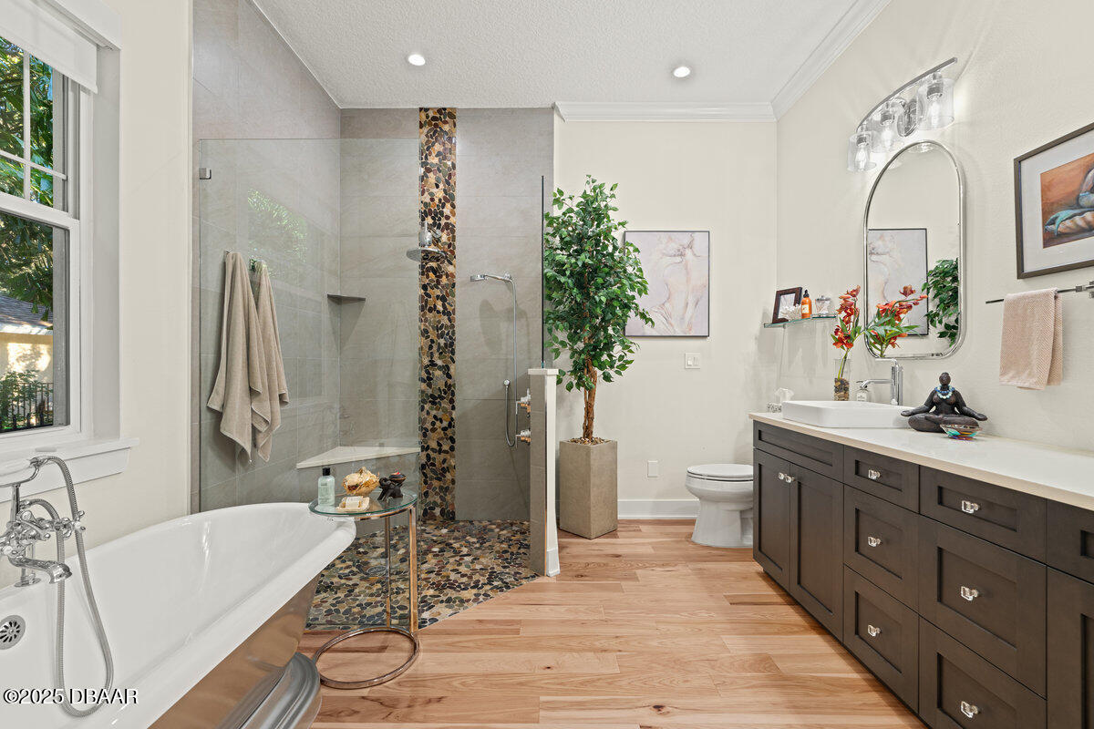 54 Ocean Way Drive Ponce Inlet, FL 32127 - Photo 27 of 76 a spacious bathroom with a double vanity sink a large mirror a bathtub and next to a window