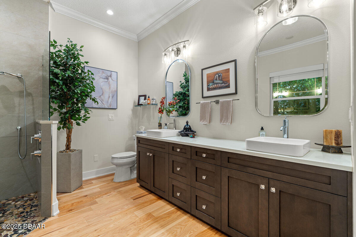 54 Ocean Way Drive Ponce Inlet, FL 32127 - Photo 28 of 76 a spacious bathroom with double vanity a toilet a large mirror and a shower