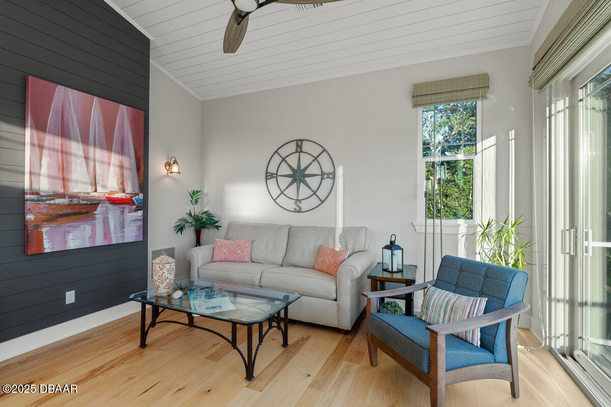 54 Ocean Way Drive Ponce Inlet, FL 32127 - Photo 33 of 76 a living room with furniture a large window and wooden floor