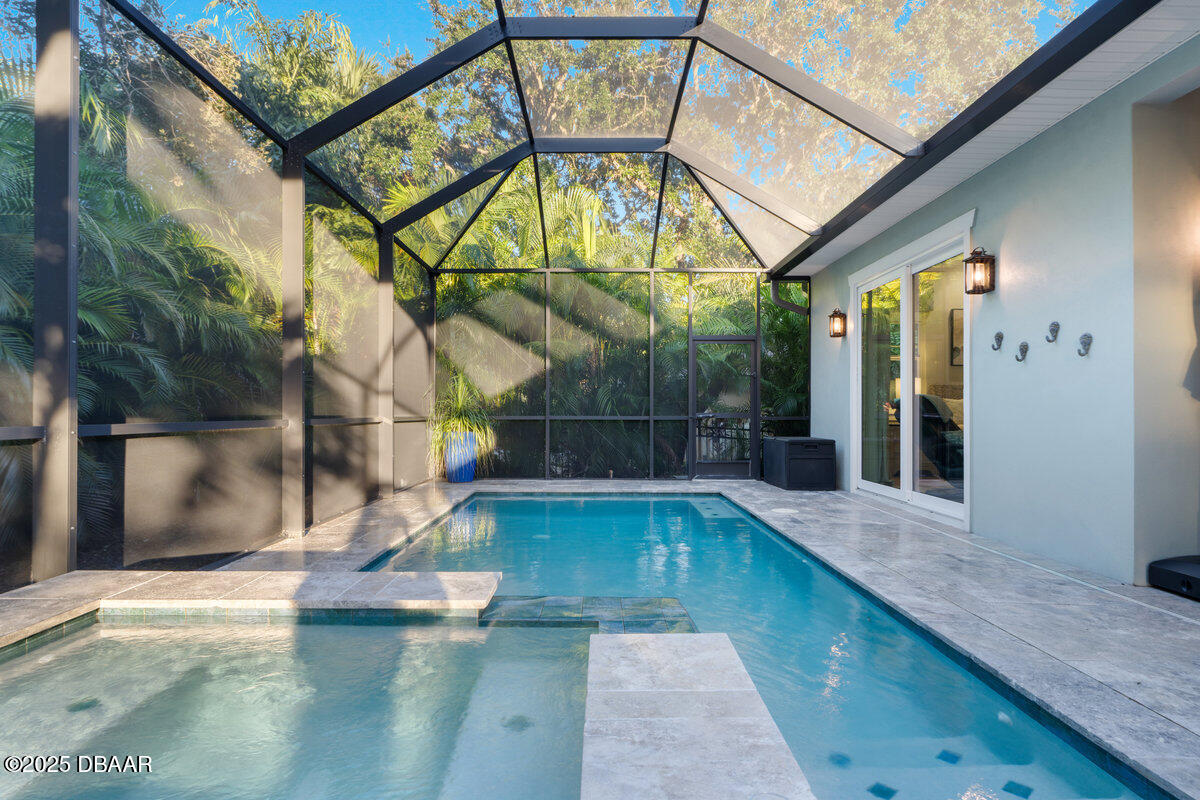 54 Ocean Way Drive Ponce Inlet, FL 32127 - Photo 47 of 76 a view of a swimming pool with a porch