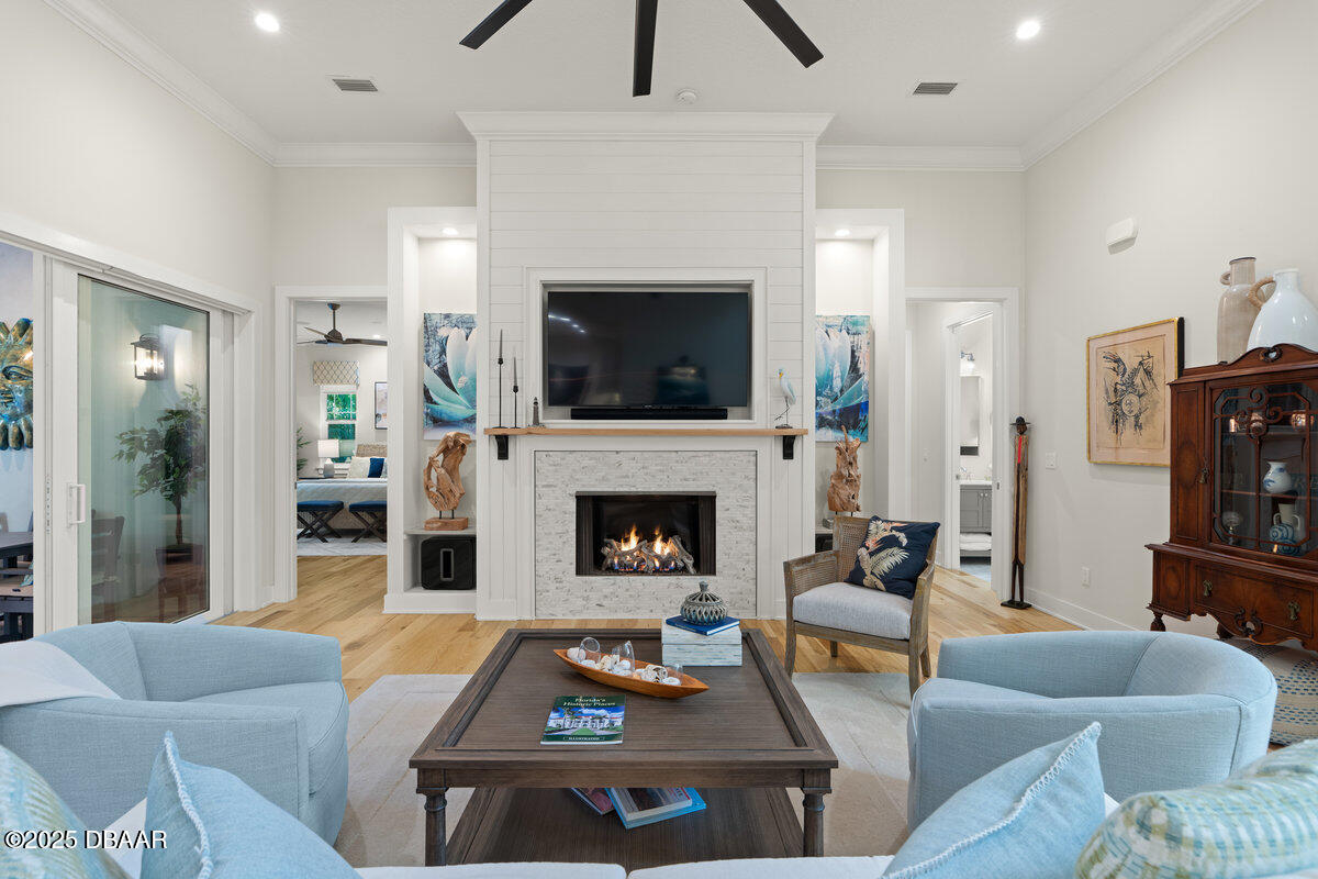 54 Ocean Way Drive Ponce Inlet, FL 32127 - Photo 5 of 76 a living room with furniture a fireplace and a flat screen tv