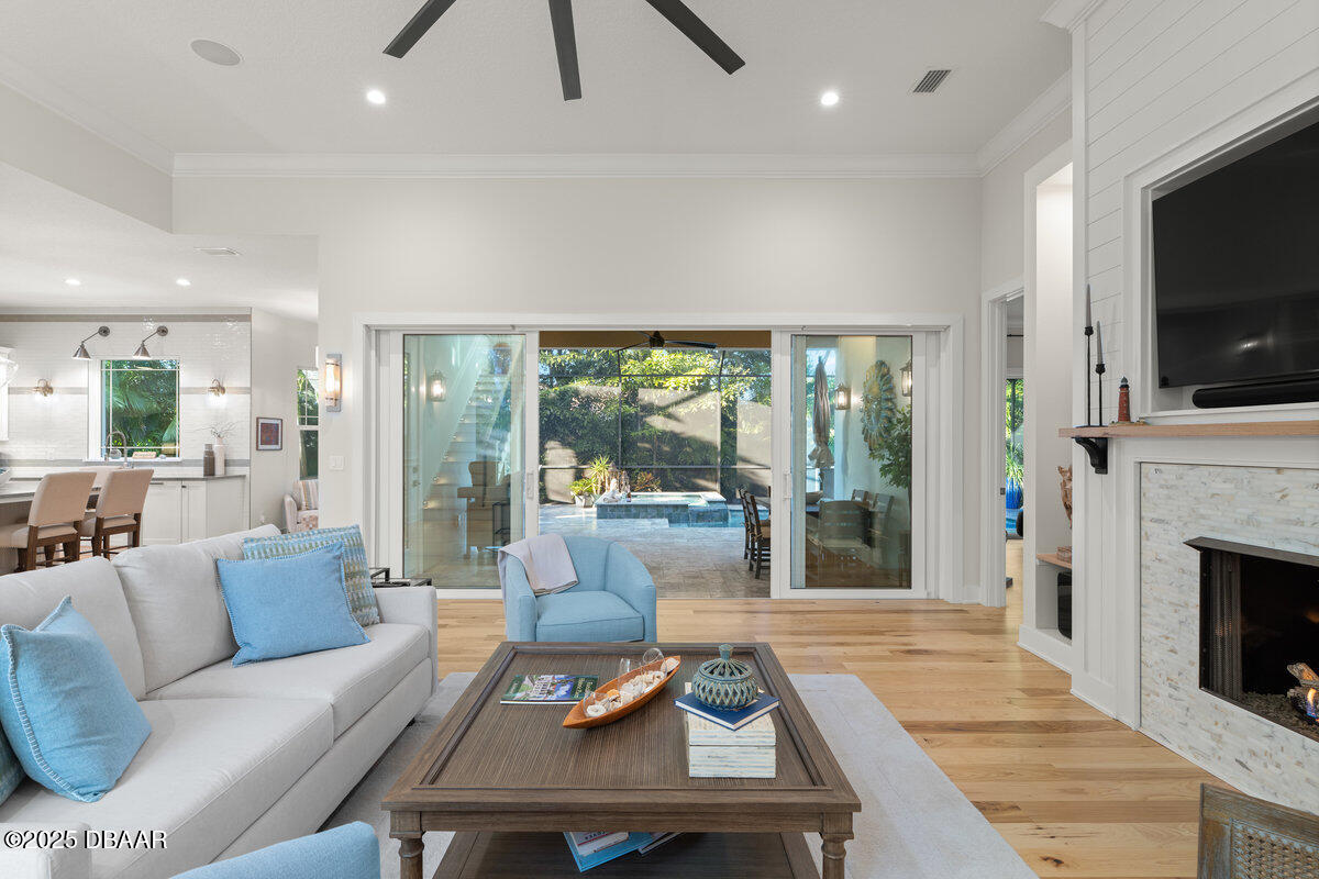 54 Ocean Way Drive Ponce Inlet, FL 32127 - Photo 6 of 76 a living room with furniture a flat screen tv and a fireplace