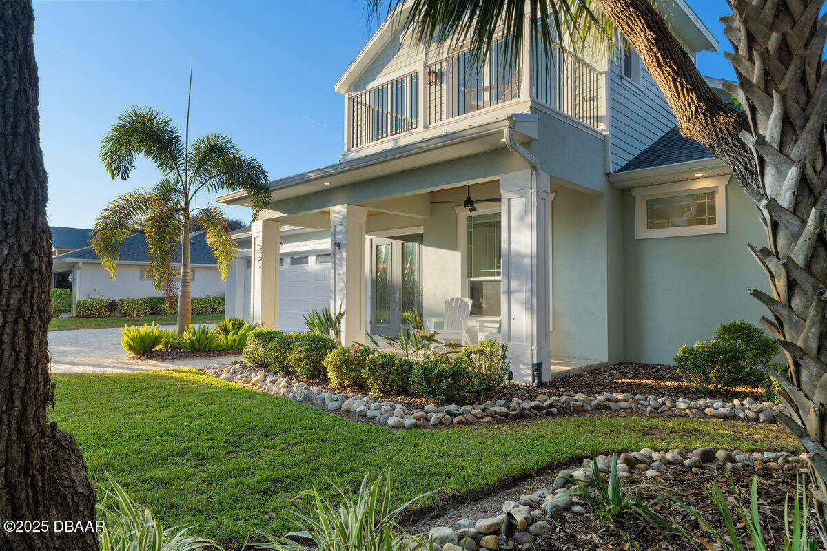 54 Ocean Way Drive Ponce Inlet, FL 32127 - Photo 62 of 76 a front view of a house with a garden