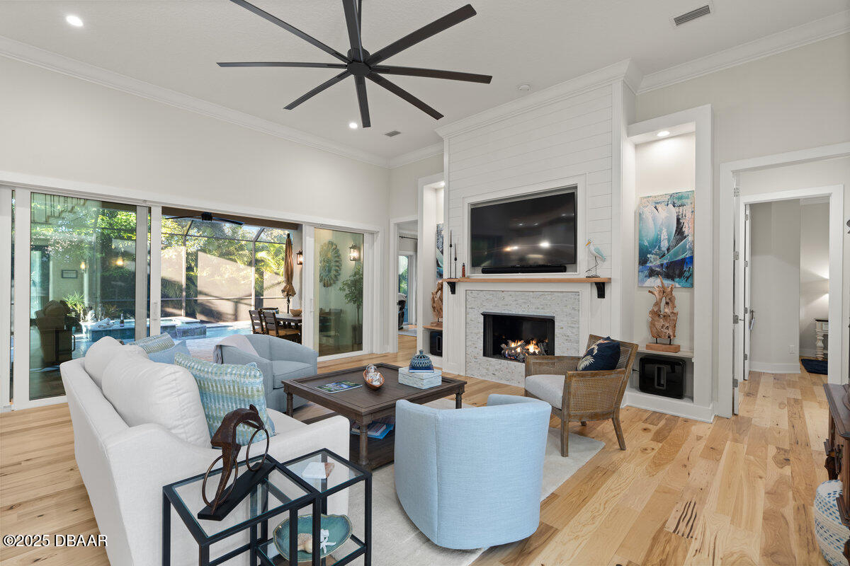 54 Ocean Way Drive Ponce Inlet, FL 32127 - Photo 10 of 76 a living room with furniture a fireplace and a flat screen tv