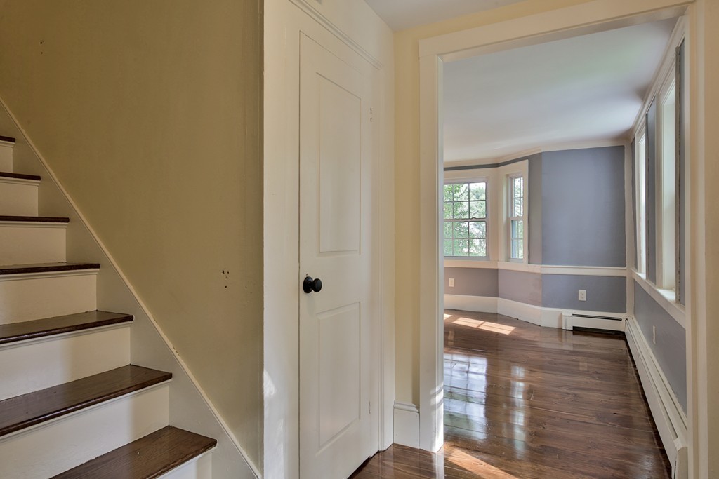 619 Main Street Boxford, MA 01921 - Photo 11 of 29 a view of a hallway with wooden floor and staircase