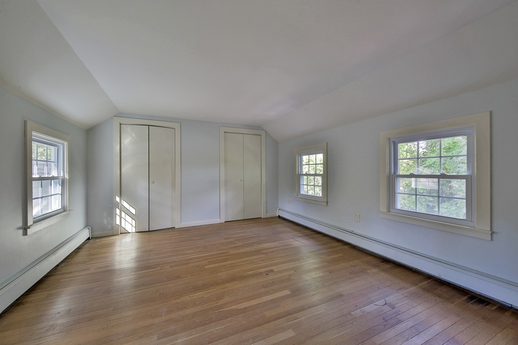 619 Main Street Boxford, MA 01921 - Photo 16 of 29 an empty room with wooden floor and windows