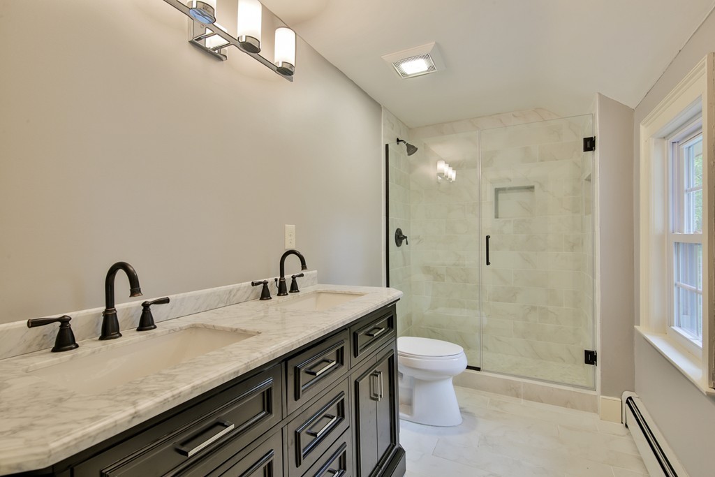 619 Main Street Boxford, MA 01921 - Photo 6 of 29 a bathroom with a double vanity sink toilet and shower