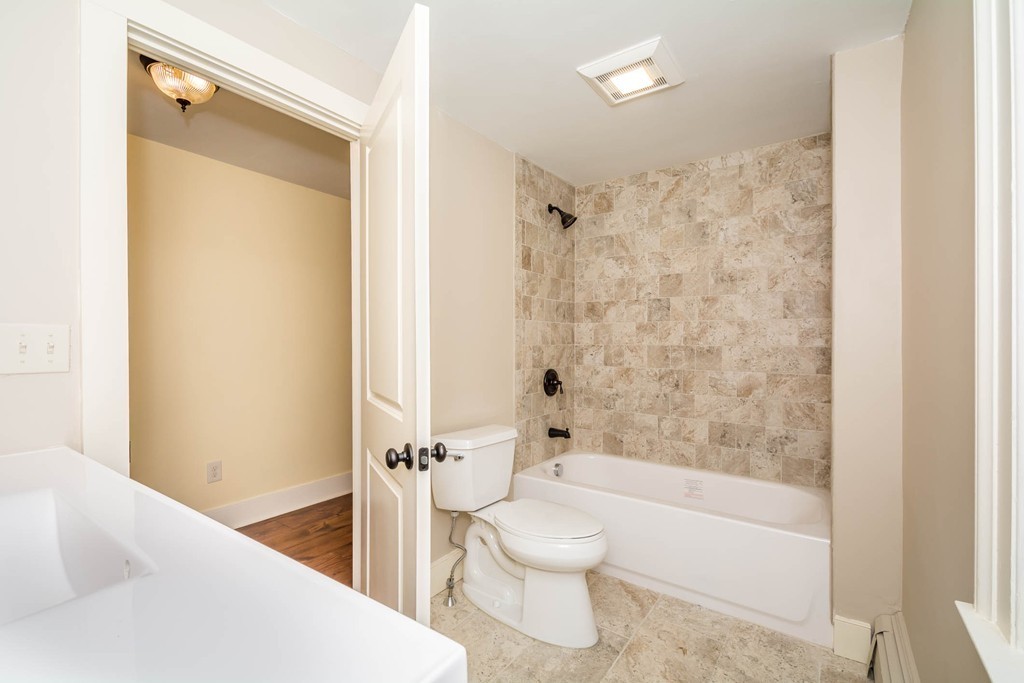 619 Main Street Boxford, MA 01921 - Photo 9 of 29 a bathroom with a toilet and a bathtub