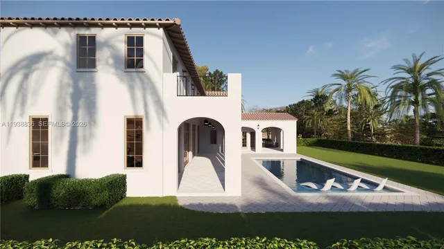 a view of a white house with a yard and potted plants