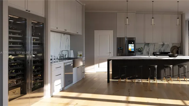 a kitchen with stainless steel appliances kitchen island granite countertop a refrigerator and cabinets