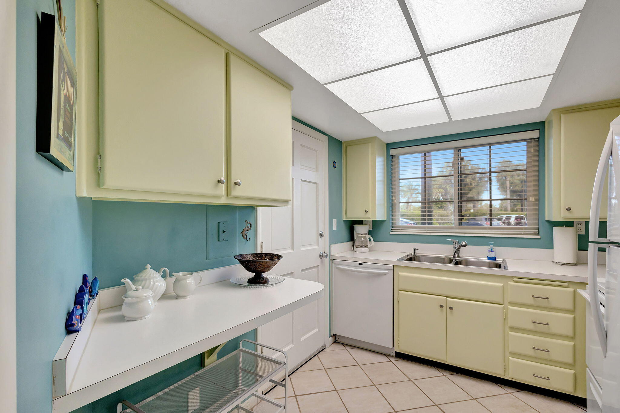 50 Celestial Way, Unit 108 Juno Beach, FL 33408 - Photo 17 of 54 a kitchen with white cabinets and white appliances