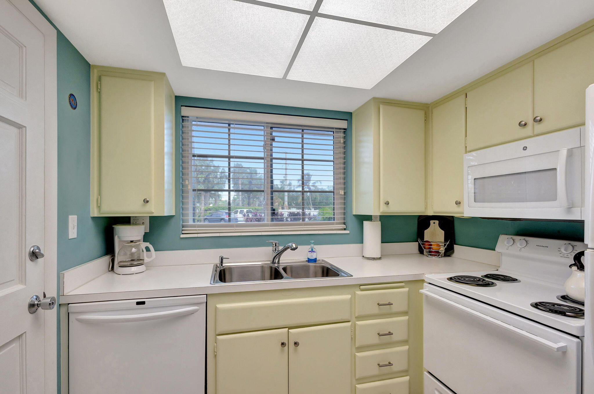 50 Celestial Way, Unit 108 Juno Beach, FL 33408 - Photo 18 of 54 a kitchen with appliances a sink and cabinets