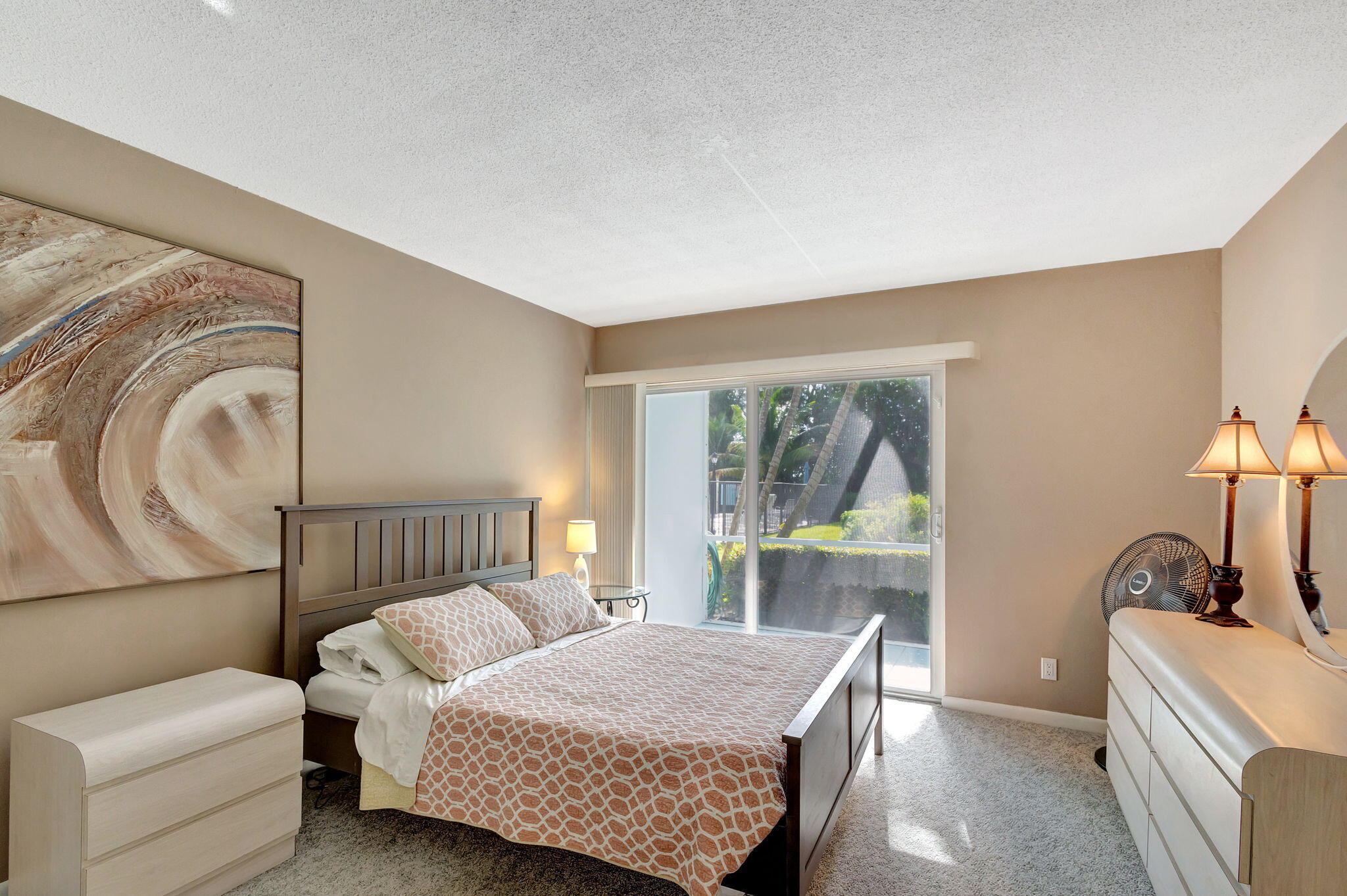 50 Celestial Way, Unit 108 Juno Beach, FL 33408 - Photo 21 of 54 a bedroom with a bed and large window with balcony view