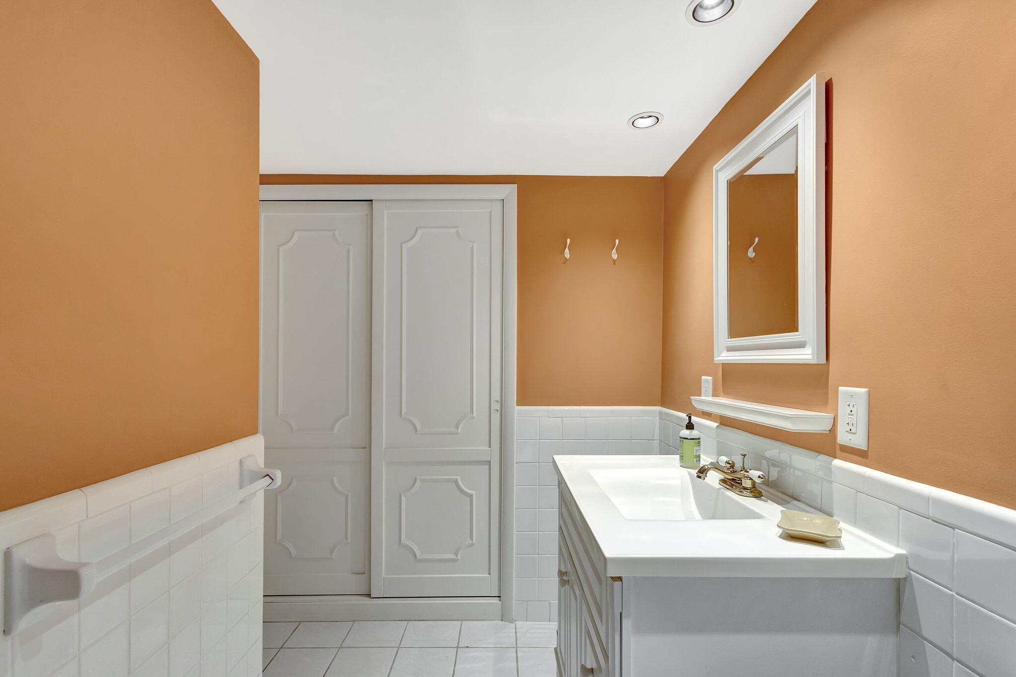 50 Celestial Way, Unit 108 Juno Beach, FL 33408 - Photo 26 of 54 a bathroom with a sink a vanity and a mirror