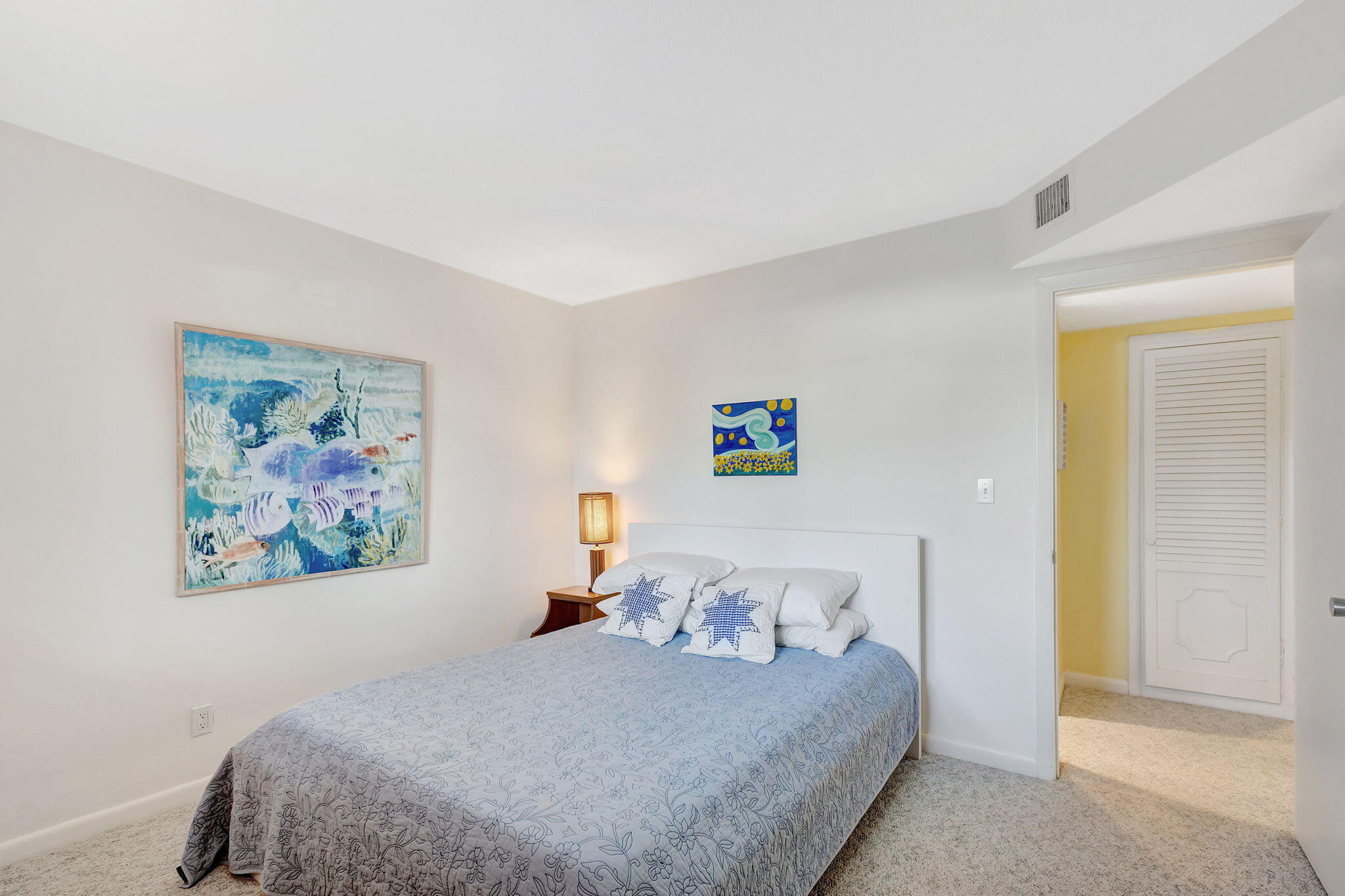 50 Celestial Way, Unit 108 Juno Beach, FL 33408 - Photo 28 of 54 a bedroom with a bed and painting on the wall