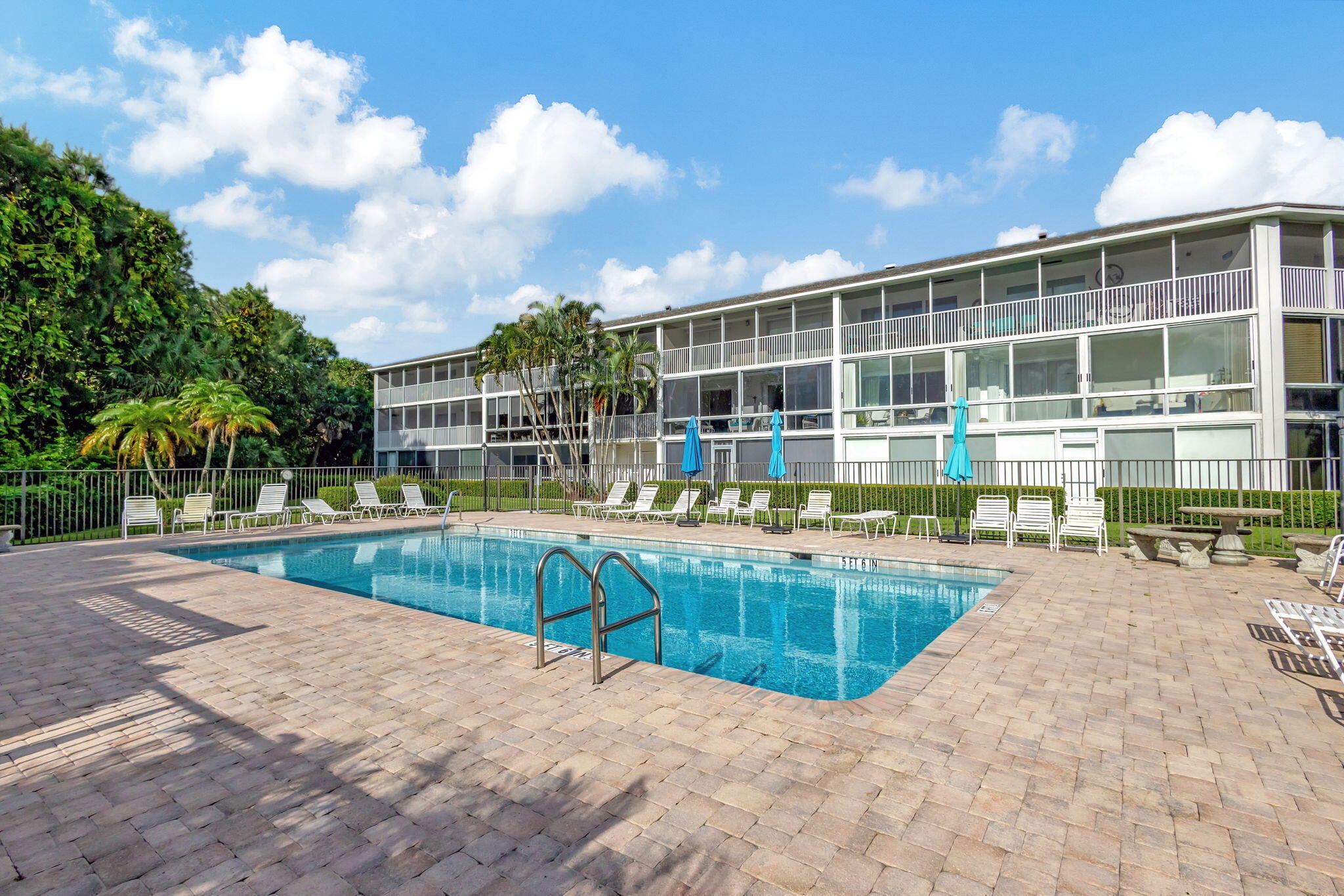 50 Celestial Way, Unit 108 Juno Beach, FL 33408 - Photo 40 of 54 a view of a house with a swimming pool and sitting area