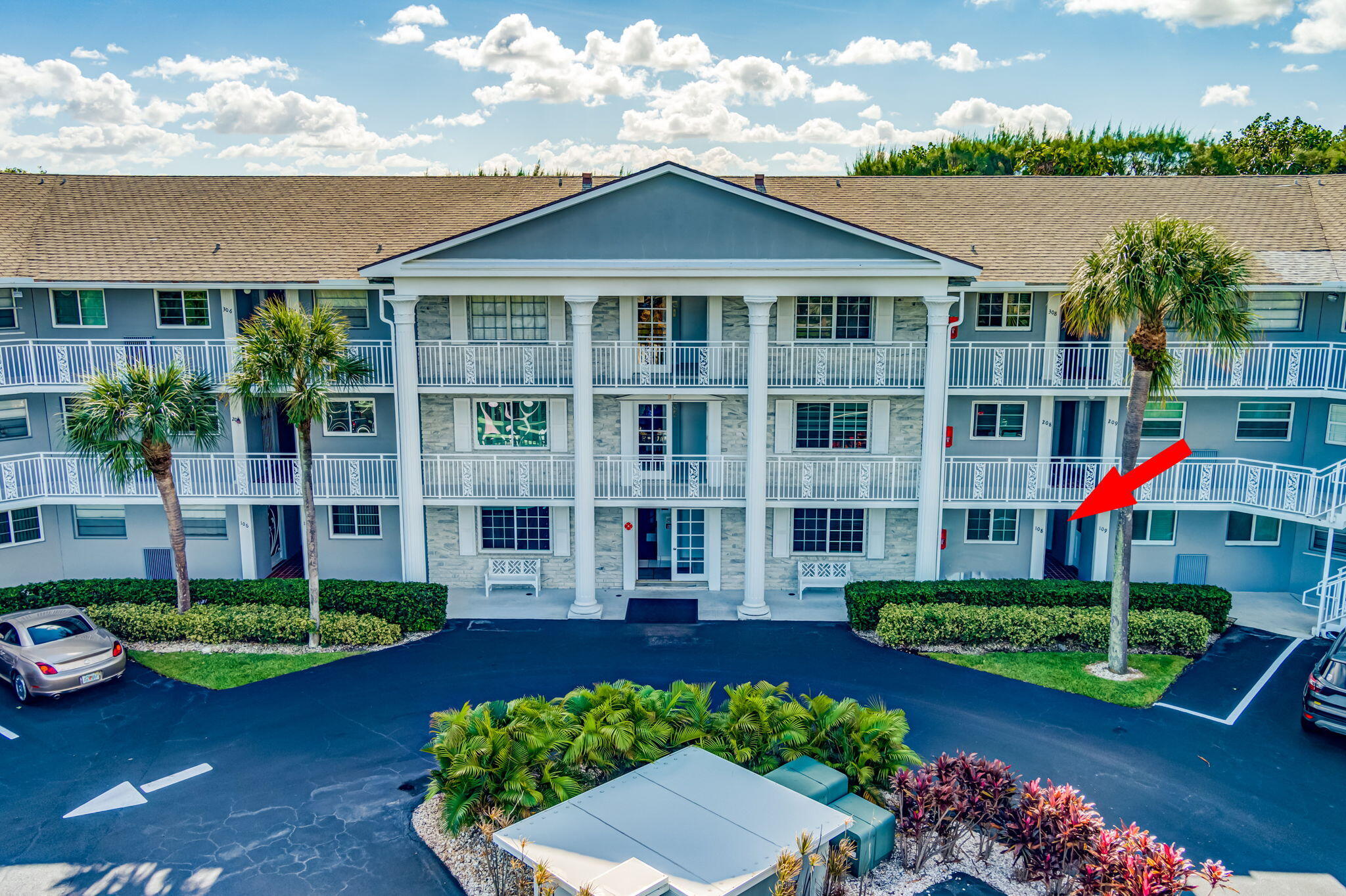 50 Celestial Way, Unit 108 Juno Beach, FL 33408 - Photo 46 of 54 a front view of a house with a yard and potted plants