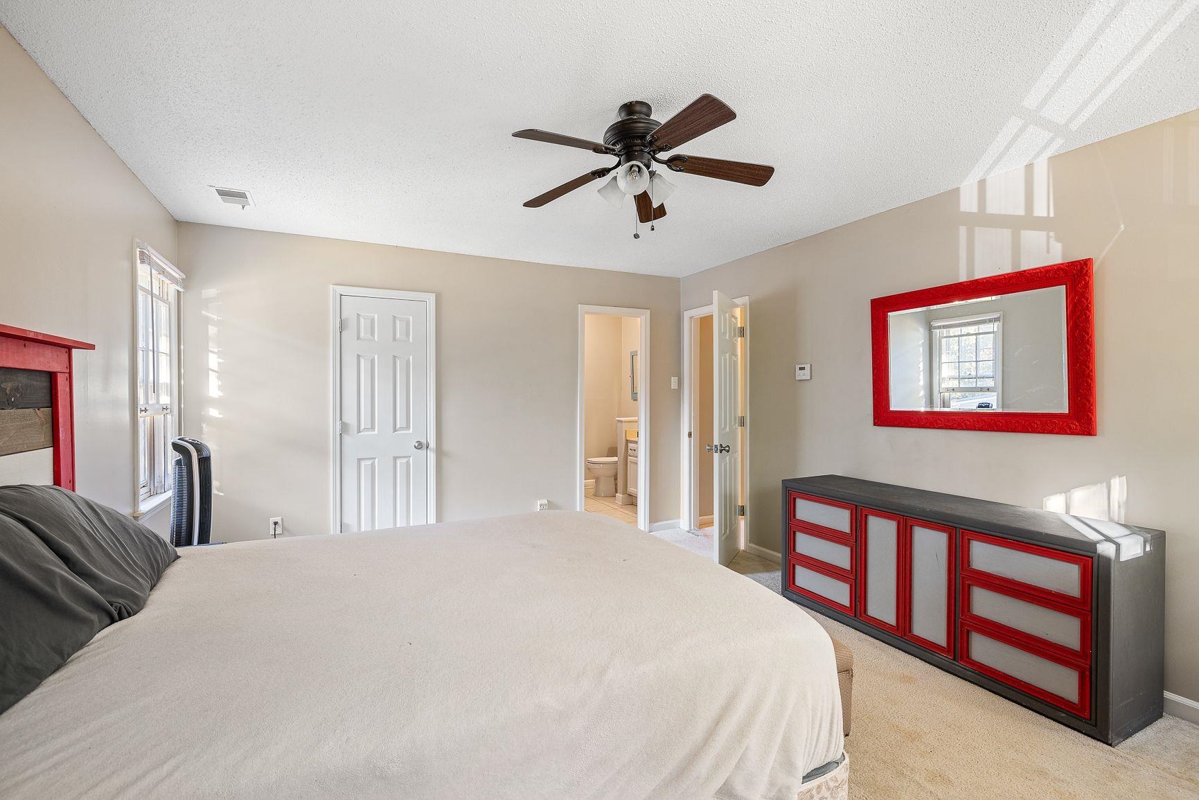 429 Dove Valley Road Collierville, TN 38017 - Photo 19 of 24 a bedroom with a large bed and a chandelier