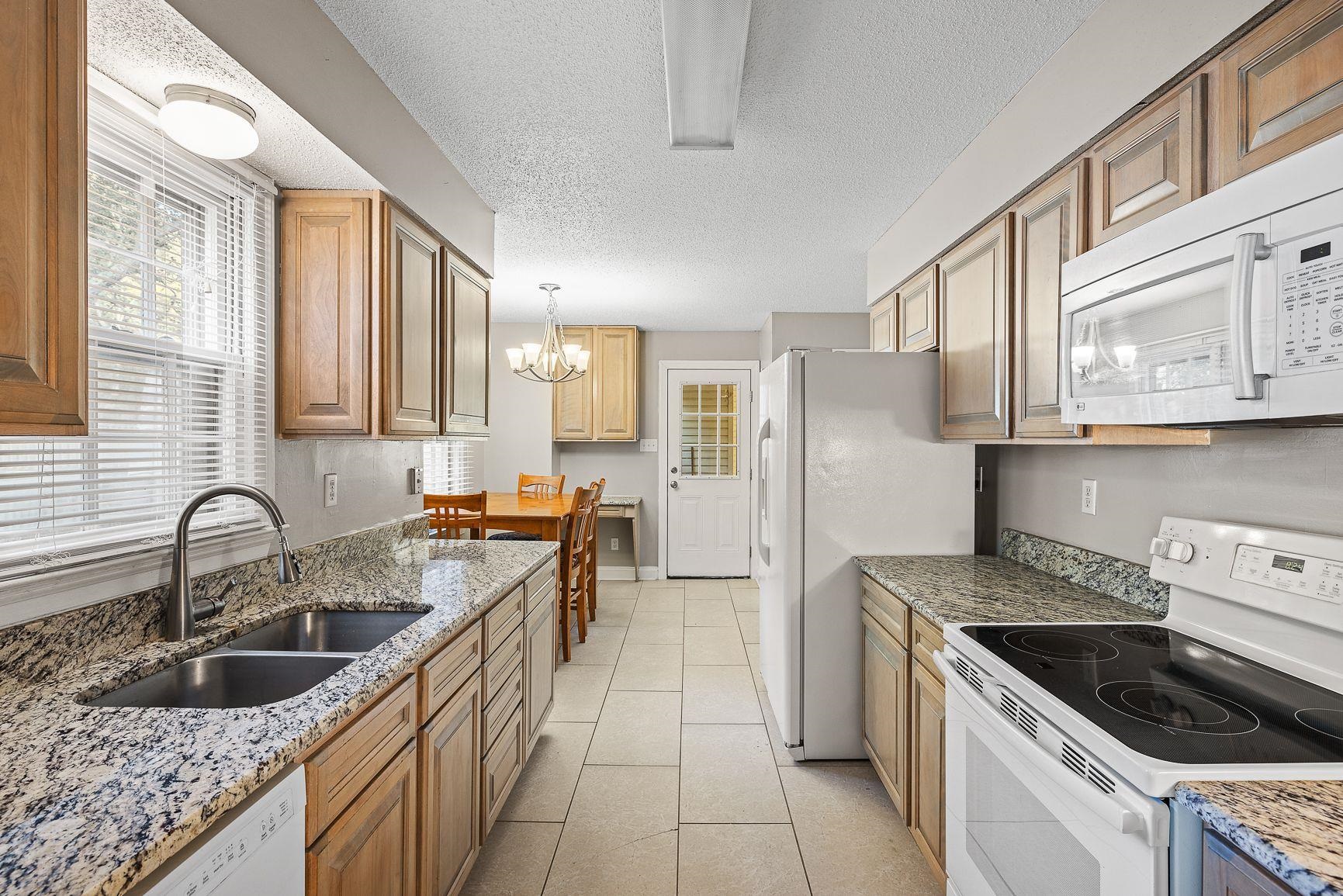 429 Dove Valley Road Collierville, TN 38017 - Photo 9 of 24 a kitchen with a sink stove top oven and cabinets