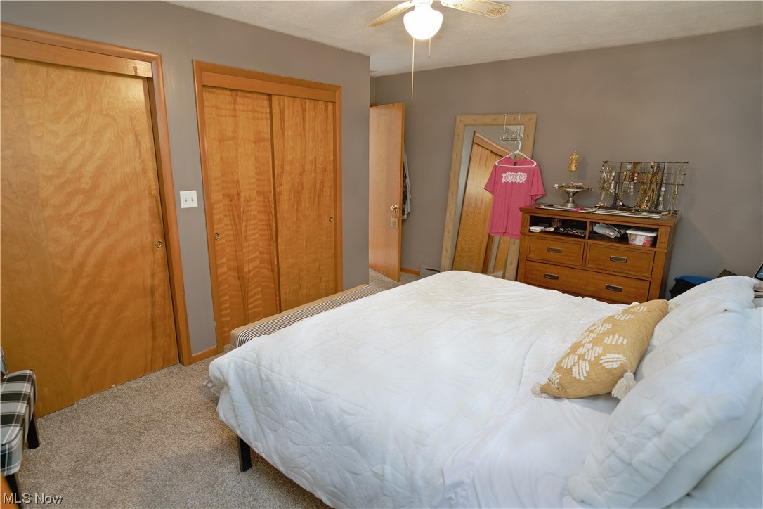 4061 Marks Rootstown, OH 44272 - Photo 14 of 25 Carpeted bedroom featuring multiple closets and ceiling fan