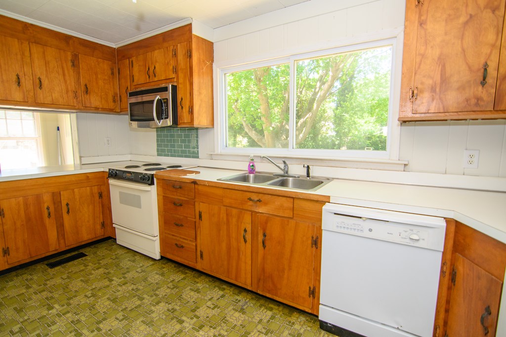 24432 Maxwell Street Parksley, VA 23421 - Photo 8 of 39 a kitchen with sink cabinets and window