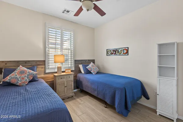 a bedroom with a bed and a chandelier