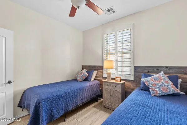 a bedroom with a large bed and a window