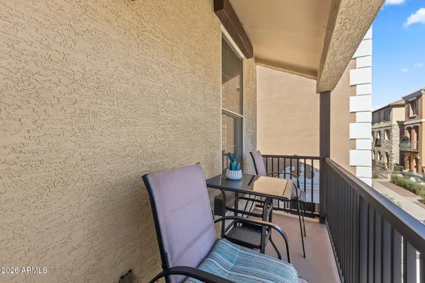 a view of a patio with a table and chairs