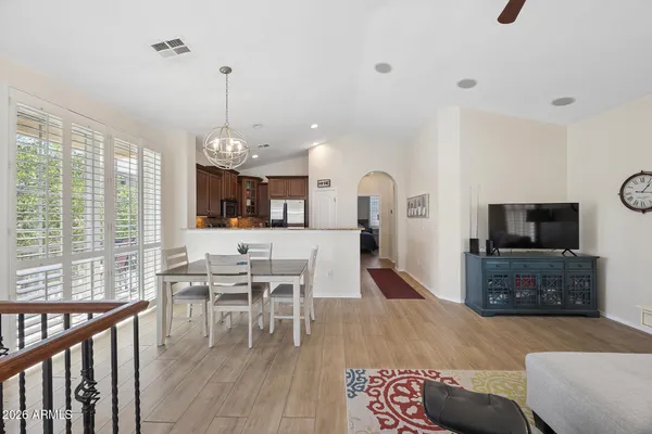 a kitchen with stainless steel appliances granite countertop a sink stove refrigerator and microwave