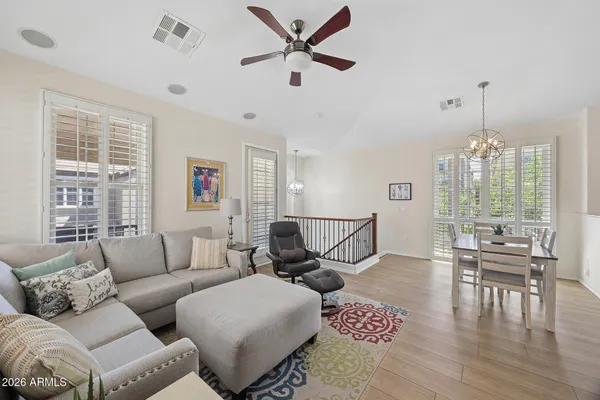 a living room with furniture a flat screen tv and a large window
