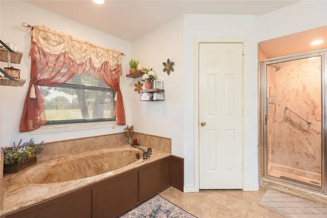 a kitchen with granite countertop white cabinets and stainless steel appliances