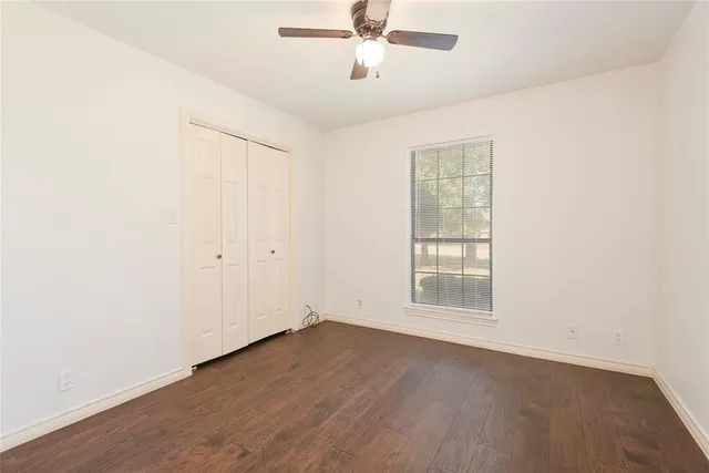 a living room with stainless steel appliances kitchen island granite countertop a sink and cabinets