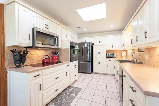 a view of swimming pool with lawn chairs and large trees