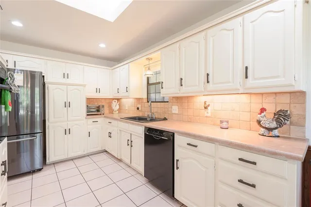 a view of swimming pool with lawn chairs and plants