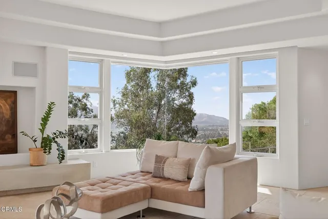 a large kitchen with cabinets chairs and chandelier