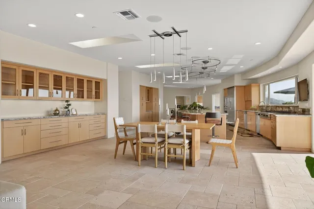a kitchen with stainless steel appliances granite countertop a sink and a refrigerator