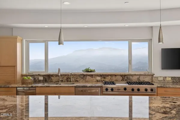 a bathroom with a granite countertop sink and mirror