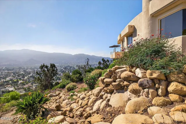 a view of a house with backyard and glass windows