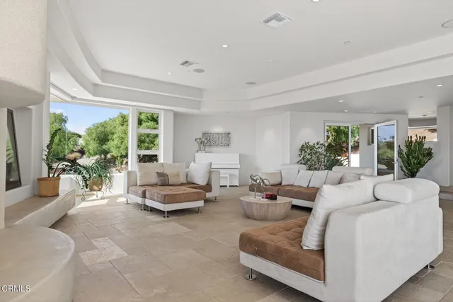 an empty room with cabinet and a potted plant