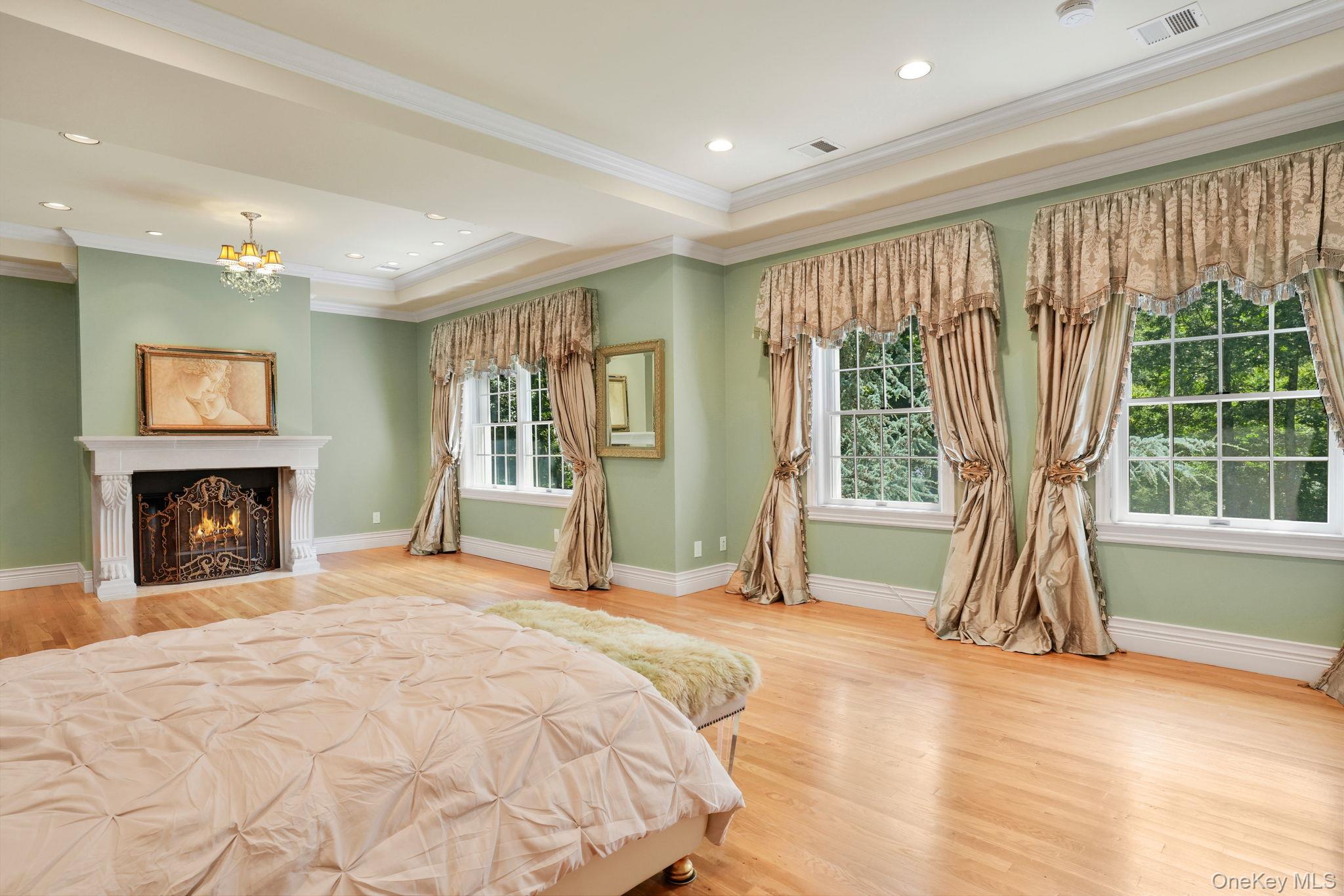 4 Hageman Court Katonah, NY 10536 - Photo 21 of 47 a spacious bedroom with a bed and a fireplace
