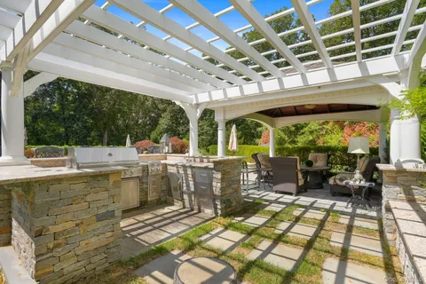 a view of a patio with lawn chairs next to a yard